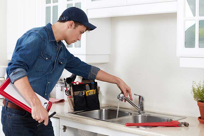 guy fixing a home faucet